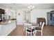 Open-concept dining area featuring a round wooden table and natural light from nearby windows at 11056 Little Blue Heron Dr, Riverview, FL 33579