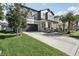 Charming two-story home with a well-manicured lawn and a two-car garage on a sunny day at 11056 Little Blue Heron Dr, Riverview, FL 33579