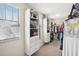 Well-organized walk-in closet with built-in shelving and hanging racks for optimal storage at 11056 Little Blue Heron Dr, Riverview, FL 33579