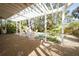 Covered backyard patio featuring a hammock and well-manicured landscaping at 112 13Th Ave, Indian Rocks Beach, FL 33785
