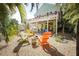 Private backyard featuring colorful chairs surrounding a fire pit at 112 13Th Ave, Indian Rocks Beach, FL 33785