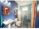 Modern bathroom featuring blue tiled walls, sleek fixtures, and a uniquely designed shower at 112 13Th Ave, Indian Rocks Beach, FL 33785