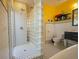 Bathroom with glass block divider, black and white tile, shower, and modern vanity at 112 13Th Ave, Indian Rocks Beach, FL 33785