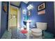 Bathroom features blue walls, tiled floors, and a simple white sink and toilet at 112 13Th Ave, Indian Rocks Beach, FL 33785