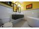 Bathroom with double vanity, black and white tile, soaking tub, and art at 112 13Th Ave, Indian Rocks Beach, FL 33785