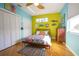 Bright bedroom with wood floors, ceiling fan, and colorful decor provides a cheerful ambiance at 112 13Th Ave, Indian Rocks Beach, FL 33785