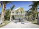 Charming two-story home with white trim, a balcony, a two-car garage, and a beautifully landscaped yard at 112 13Th Ave, Indian Rocks Beach, FL 33785