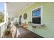 Inviting porch with comfortable seating, a small table with chairs, and stylish decor, perfect for relaxation at 112 13Th Ave, Indian Rocks Beach, FL 33785