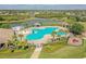 Aerial view of the community pool with surrounding landscaping and playground at 12304 Silton Peace Dr, Riverview, FL 33579