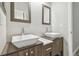 Modern bathroom featuring double vanities with vessel sinks and sleek wood cabinetry at 12304 Silton Peace Dr, Riverview, FL 33579