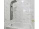 White and marble tiled bathtub and shower with modern shower fixtures at 12304 Silton Peace Dr, Riverview, FL 33579