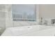 Modern bathroom featuring a freestanding bathtub with marble tile and stainless steel fixtures at 12304 Silton Peace Dr, Riverview, FL 33579