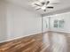 Spacious bedroom featuring hardwood floors, neutral paint, and ceiling fan at 12304 Silton Peace Dr, Riverview, FL 33579