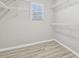 Bright closet with wire shelving and wood-style floors with a window to let in the sun at 12304 Silton Peace Dr, Riverview, FL 33579