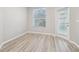 Bright dining area with wood-look floors, a window, and glass door access to outdoor space at 12304 Silton Peace Dr, Riverview, FL 33579