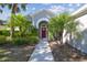 Charming home featuring a bright red front door, manicured landscaping and walkway at 12304 Silton Peace Dr, Riverview, FL 33579