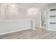 Bright hallway features wood-look flooring and a half wall; bathroom is visible at 12304 Silton Peace Dr, Riverview, FL 33579