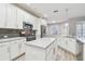 Bright kitchen with white cabinetry, marble countertops, a stylish island, and stainless steel appliances at 12304 Silton Peace Dr, Riverview, FL 33579