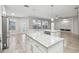 Spacious kitchen featuring white cabinets, a large island, stainless steel appliances, and wood-look floors at 12304 Silton Peace Dr, Riverview, FL 33579
