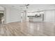 Spacious living room flowing into bright kitchen and dining area, lots of windows, and modern floors at 12304 Silton Peace Dr, Riverview, FL 33579