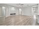 Open living area with wood-look floors, a modern fireplace accent wall, and a ceiling fan at 12304 Silton Peace Dr, Riverview, FL 33579
