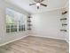 Bright office space with hardwood floors, shelving, and a large window overlooking greenery at 12304 Silton Peace Dr, Riverview, FL 33579