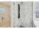 Modern shower features glass door and marble-style tile with a unique jet shower system at 12304 Silton Peace Dr, Riverview, FL 33579