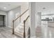 Elegant staircase with white risers, wood treads, and a charming wooden railing at 12304 Silton Peace Dr, Riverview, FL 33579