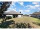 Spacious backyard with a covered patio, perfect for outdoor relaxation and entertaining at 14205 Stockwell Ln, Ruskin, FL 33573
