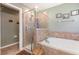 Serene bathroom with a soaking tub, separate shower, and neutral tile work at 14205 Stockwell Ln, Ruskin, FL 33573