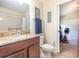 Bathroom showcasing granite countertop vanity, a shower, and linen closet at 14205 Stockwell Ln, Ruskin, FL 33573