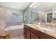 Luxurious bathroom with double sinks, soaking tub, and separate shower at 14205 Stockwell Ln, Ruskin, FL 33573