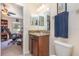 Bathroom with a granite countertop vanity and framed mirrors at 14205 Stockwell Ln, Ruskin, FL 33573