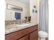 Bathroom features a shower with glass doors, granite countertop vanity, and natural light at 14205 Stockwell Ln, Ruskin, FL 33573