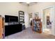 Spacious bedroom with carpeting, several book shelves, and an ensuite bathroom at 14205 Stockwell Ln, Ruskin, FL 33573