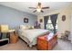 Charming bedroom featuring a ceiling fan, gray accent wall, and a cozy window nook with natural light at 14205 Stockwell Ln, Ruskin, FL 33573