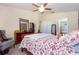 Bright bedroom with a ceiling fan, dresser, and access to the ensuite bathroom at 14205 Stockwell Ln, Ruskin, FL 33573