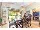Bright dining room with sliding doors leading to the backyard and comfortable seating for six at 14205 Stockwell Ln, Ruskin, FL 33573