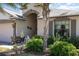 Close-up of a charming front porch, displaying decorative plants, American flag and inviting details at 14205 Stockwell Ln, Ruskin, FL 33573