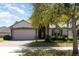 Charming single-story home featuring a brick driveway and lush landscaping around the property at 14205 Stockwell Ln, Ruskin, FL 33573