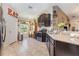 Charming kitchen featuring dark cabinets, granite countertops, and stainless steel appliances at 14205 Stockwell Ln, Ruskin, FL 33573