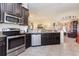 Well-equipped kitchen with stainless steel appliances and dark wood cabinets, perfect for cooking at 14205 Stockwell Ln, Ruskin, FL 33573