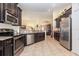 Modern kitchen with granite countertops, stainless steel appliances, and dark wood cabinets at 14205 Stockwell Ln, Ruskin, FL 33573
