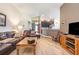 Open living space featuring a leather sofa, view into the kitchen, and laminate flooring at 14205 Stockwell Ln, Ruskin, FL 33573