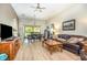 Bright and airy living room with laminate floors, fan, and comfortable seating area and dining room combination at 14205 Stockwell Ln, Ruskin, FL 33573