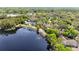 Aerial view showcases the lakefront property and surrounding neighborhood with lush greenery and waterfront views at 2206 Green Oaks Ln, Tampa, FL 33612