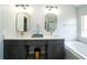 Elegant bathroom with dual sinks, a soaking tub, modern finishes and luxury mirrors at 2206 Green Oaks Ln, Tampa, FL 33612