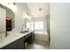 Elegant bathroom with dual vanities, soaking tub, and contemporary fixtures at 2206 Green Oaks Ln, Tampa, FL 33612