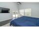 Relaxing bedroom with sliding glass doors, large window, and dark vinyl wood flooring at 2206 Green Oaks Ln, Tampa, FL 33612