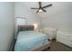 Comfortable bedroom with a crib, ceiling fan and neutral decor at 2206 Green Oaks Ln, Tampa, FL 33612